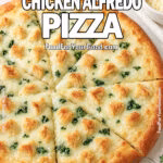 Freshly baked Creamy Chicken Alfredo Pizza on marble background, topped with shredded golden chicken, melted mozzarella, and Alfredo sauce with spinach peeking beneath the cheese.
