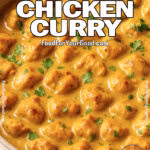 Golden Creamy Coconut Chicken Curry in a beige bowl with fresh cilantro on marble surface