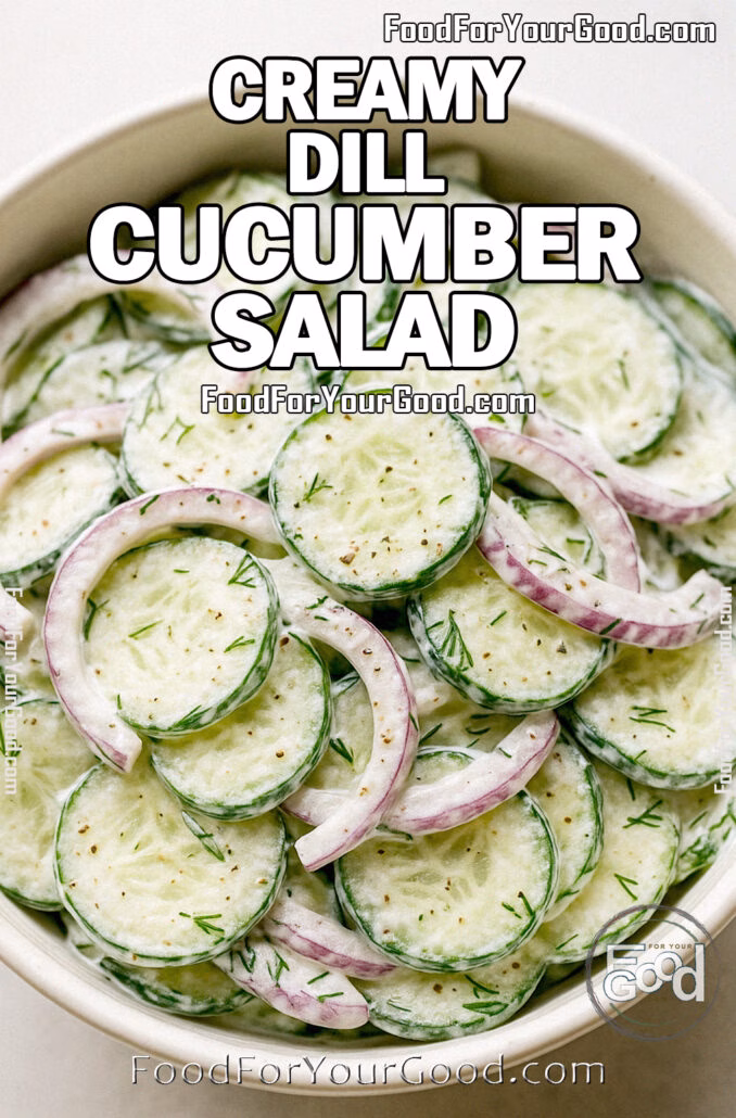 Creamy Dill Cucumber Salad in a white ceramic bowl with red onions and fresh dill on marble background