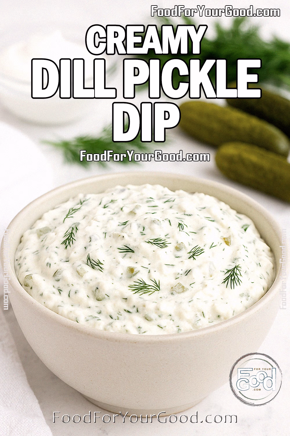 Creamy Dill Pickle Dip Recipe on FoodForYourGood.com A creamy dill pickle dip in a beige bowl topped with fresh dill, with pickles, dill sprigs, and sour cream blurred in the background on a white marble surface.