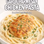 Creamy Garlic Parmesan Chicken Pasta in a white bowl with golden chicken slices, creamy sauce, and parsley garnish on marble.