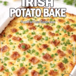 Creamy Irish Potato Bake casserole with golden melted cheese, bacon, and fresh parsley in a white baking dish on marble background.