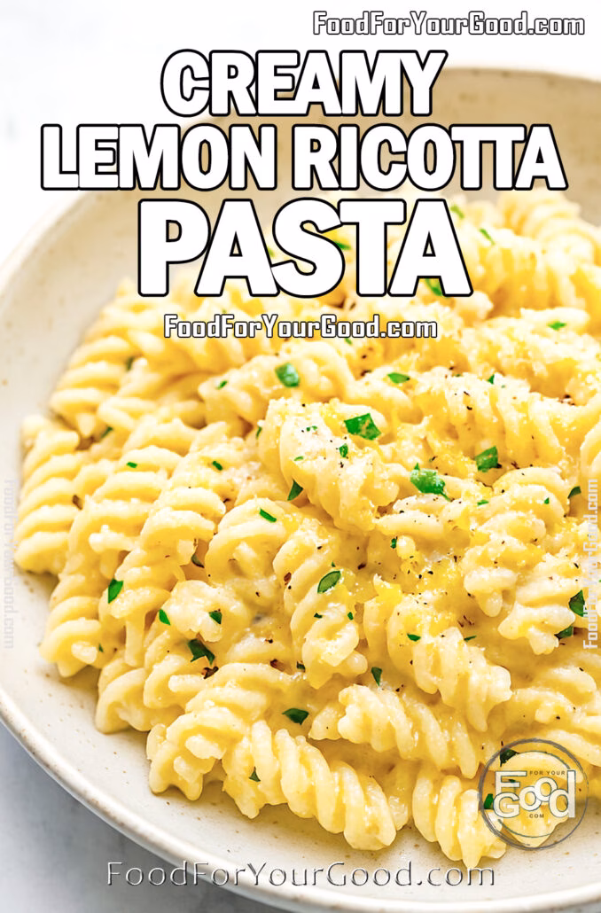 A close-up of Creamy Lemon Ricotta Pasta in a rustic white bowl, topped with herbs and lemon zest.