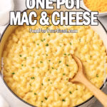 Creamy One Pot Mac & Cheese in a Dutch oven with fresh parsley and shredded cheddar on a marble surface.
