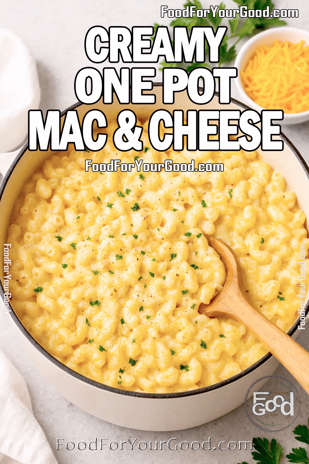 Creamy One Pot Mac & Cheese in Dutch Oven | FoodForYourGood.com Creamy One Pot Mac & Cheese in a Dutch oven with fresh parsley and shredded cheddar on a marble surface.