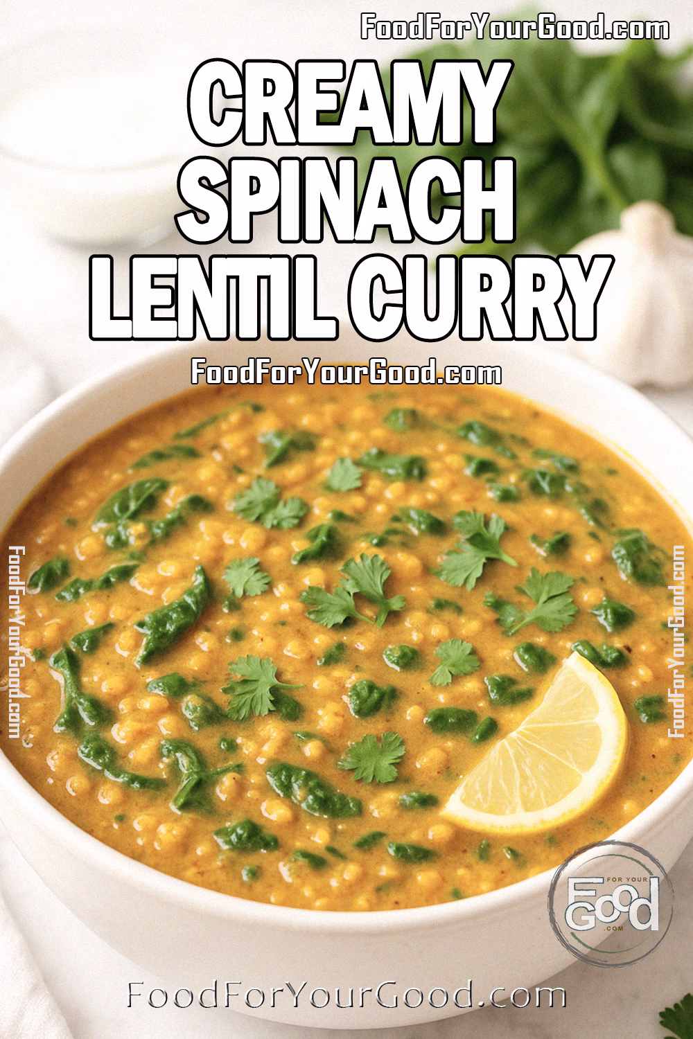 Creamy Spinach Lentil Curry Recipe – FoodForYourGood.com A creamy spinach lentil curry in a white bowl, garnished with cilantro and a lemon wedge, on a marble countertop.
