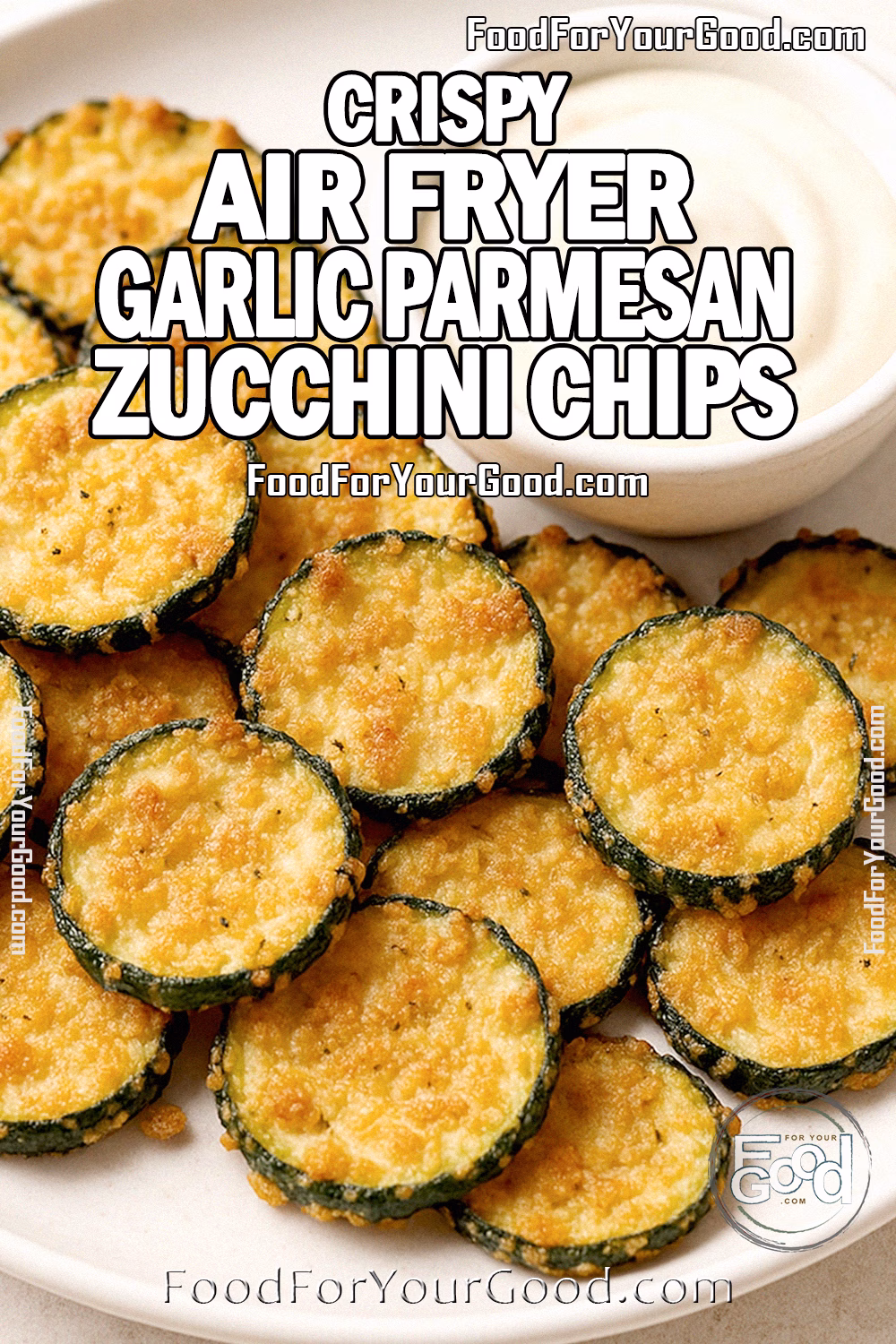 Crispy Air Fryer Garlic Parmesan Zucchini Chips – FoodForYourGood.com Crispy Air Fryer Garlic Parmesan Zucchini Chips on a white plate with a bowl of creamy dipping sauce, showing slightly uneven sizes, soft edges, and a golden breadcrumb coating.