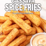 Crispy Cassava Spice Fries served on a white marble platter with creamy spicy mayo dip and fresh yuca root in the background, captured in natural daylight on FoodForYourGood.com