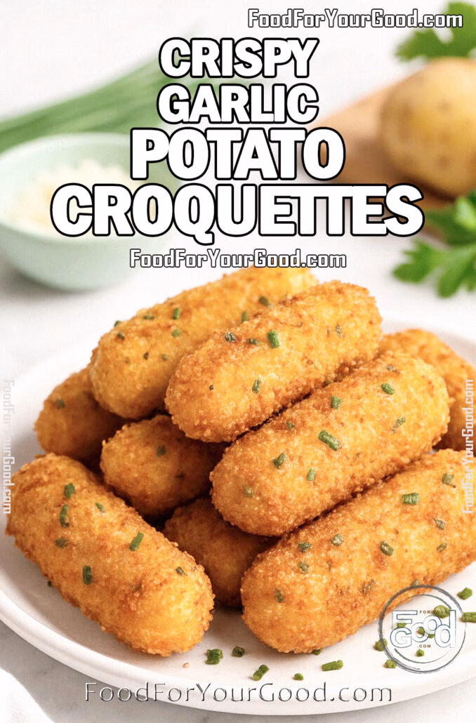 Crispy Garlic Potato Croquettes Crispy Garlic Potato Croquettes stacked on a white plate with chives, Parmesan, and potatoes on a marble background.
