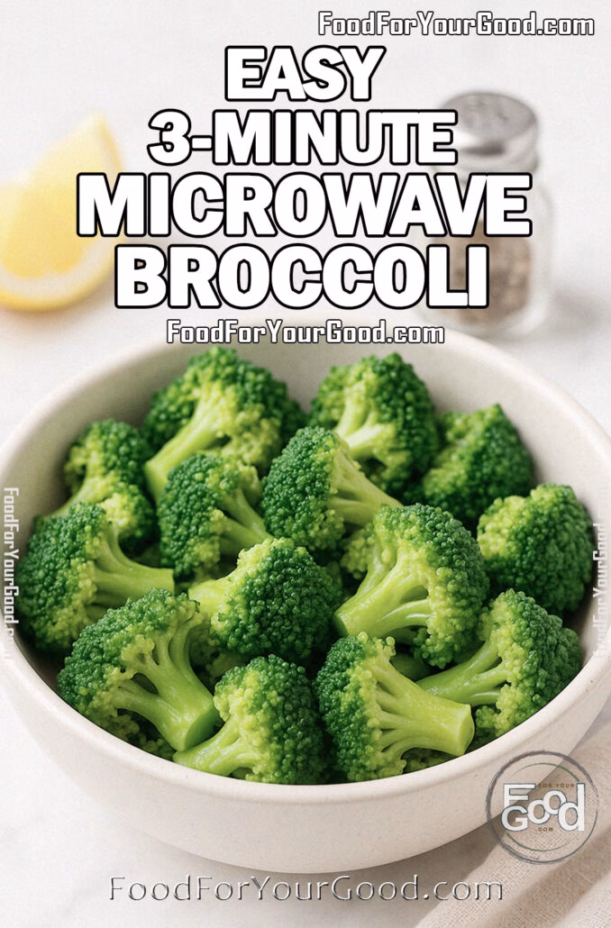 A white ceramic bowl filled with tender Easy 3-Minute Microwave Broccoli on a marble countertop with lemon wedge and olive oil in the background.