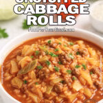 Easy Unstuffed Cabbage Rolls in a white bowl on a marble countertop, garnished with parsley and surrounded by fresh tomatoes, cabbage, and rice.