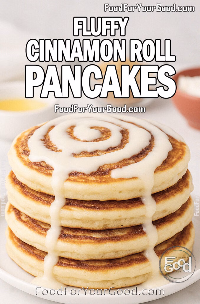 Fluffy Cinnamon Roll Pancakes A stack of Fluffy Cinnamon Roll Pancakes drizzled with cream cheese glaze, served on a white plate over marble with blurred cinnamon sticks, butter, and brown sugar in the background.