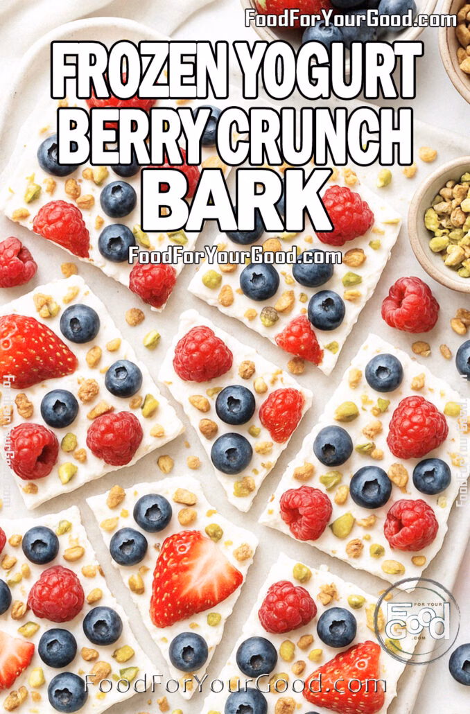 Frozen Yogurt Berry Crunch Bark Frozen Yogurt Berry Crunch Bark broken into rustic pieces on a marble tray with parchment paper, surrounded by bowls of fresh berries, granola, and pistachios.