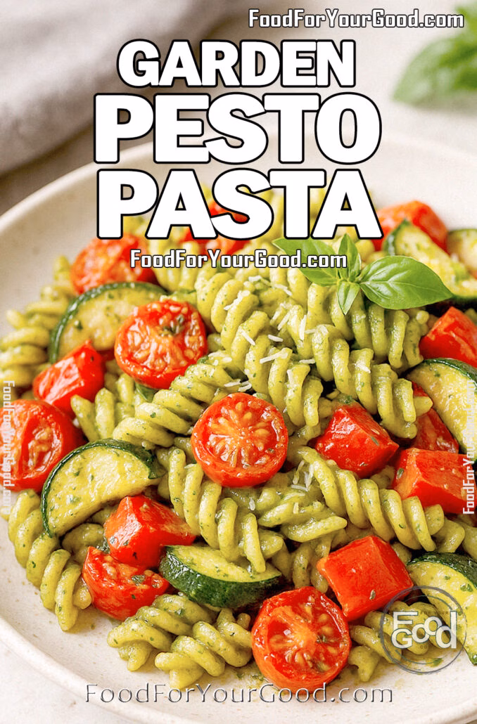Garden Pesto Pasta A bowl of Garden Pesto Pasta with roasted vegetables and fresh basil on top, served on a marble countertop.