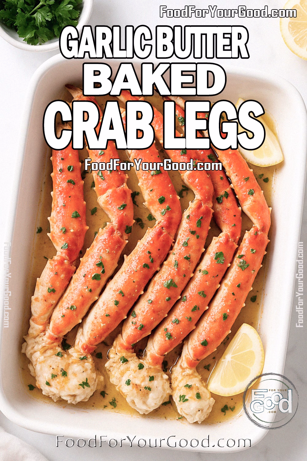 Garlic Butter Baked Crab Legs Recipe | FoodForYourGood.com Garlic Butter Baked Crab Legs served in a white dish with lemon and parsley on marble background.