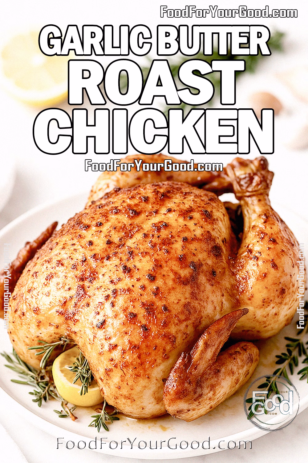 Garlic Butter Roast Chicken Recipe | FoodForYourGood.com Garlic Butter Roast Chicken on a white plate with herbs, lemon, and garlic on a marble countertop.