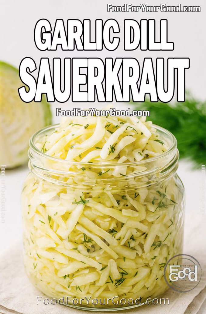 Glass jar filled with homemade garlic dill sauerkraut on a linen napkin with fresh cabbage and dill in the background