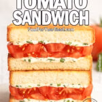Garlic Herb Tomato Sandwich stacked on marble with fresh tomato and basil in background