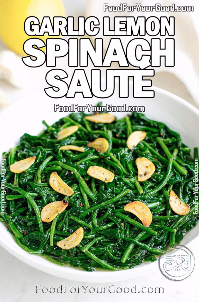 Garlic Lemon Spinach Sauté in a white bowl with garlic slices, fresh lemon, and garlic bulb in the background on white marble.
