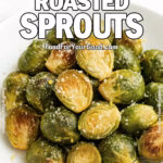 A close-up of Garlic Roasted Sprouts garnished with lemon zest and Parmesan on a white plate.