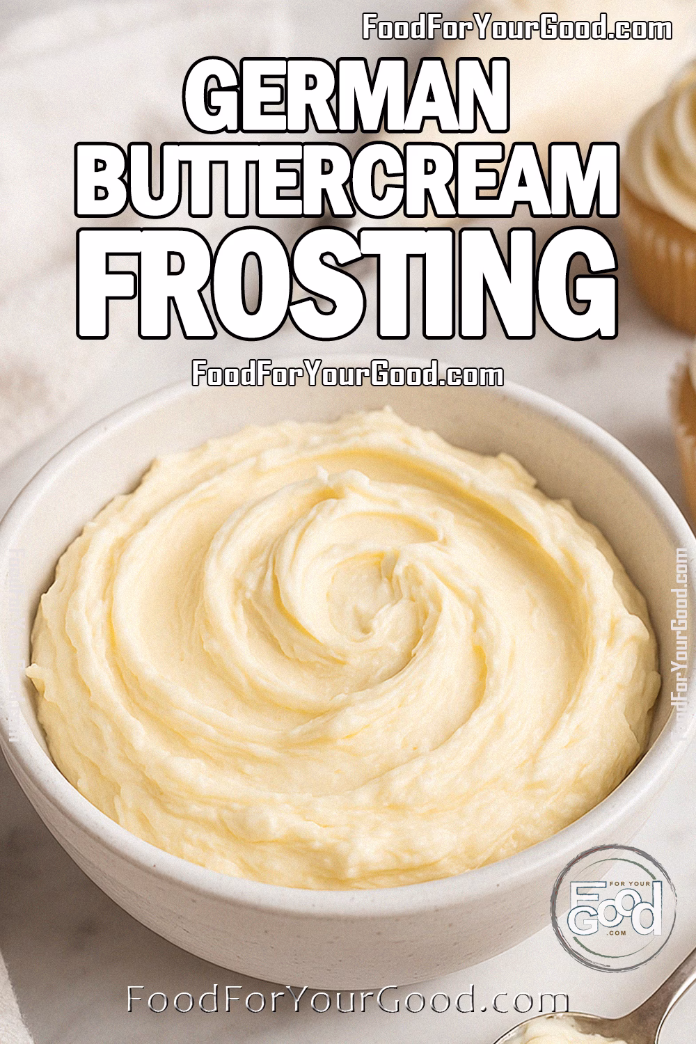 Homemade German Buttercream Frosting Recipe – FoodForYourGood.com Homemade German Buttercream Frosting in a white bowl with spoon, cupcakes, and piping bag on marble background.