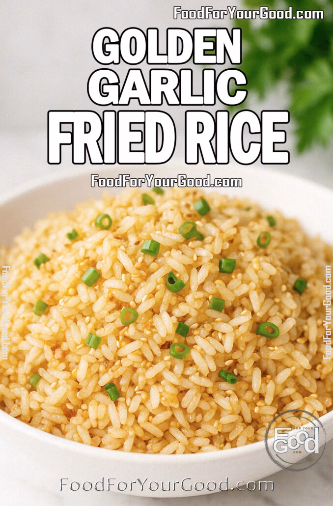 Golden Garlic Fried Rice A white bowl filled with golden garlic fried rice garnished with green onions, set on a white marble surface with fresh herbs blurred in the background.