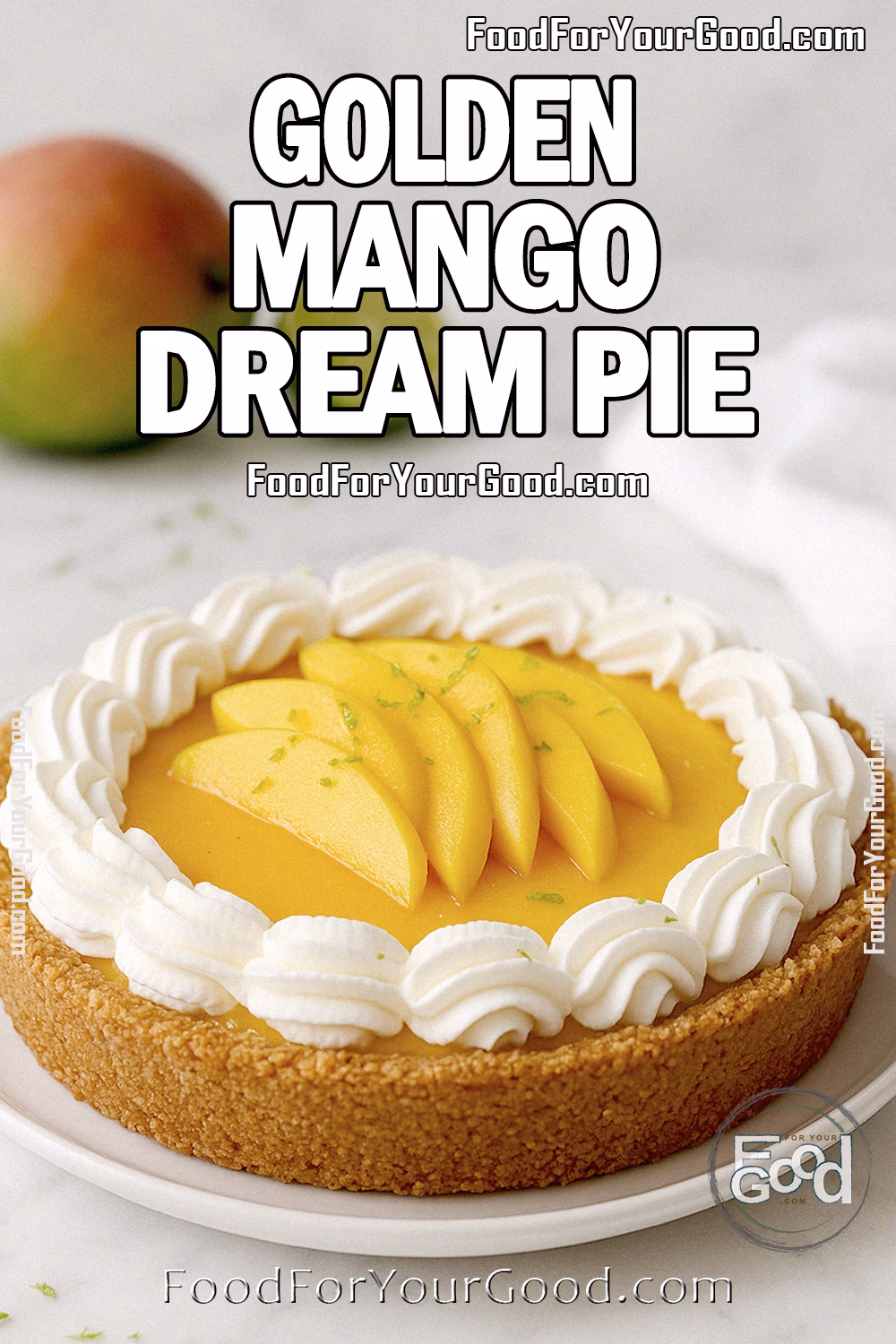 Golden Mango Dream Pie Recipe – FoodForYourGood.com Golden Mango Dream Pie on a white plate, topped with whipped cream, fresh mango slices, and lime zest on a marble countertop with mango and lime in the background.