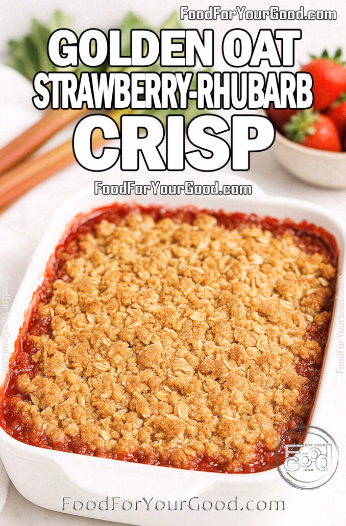 Golden Oat Strawberry-Rhubarb Crisp in a white dish with golden oat topping, fresh strawberries, and rhubarb on marble countertop.