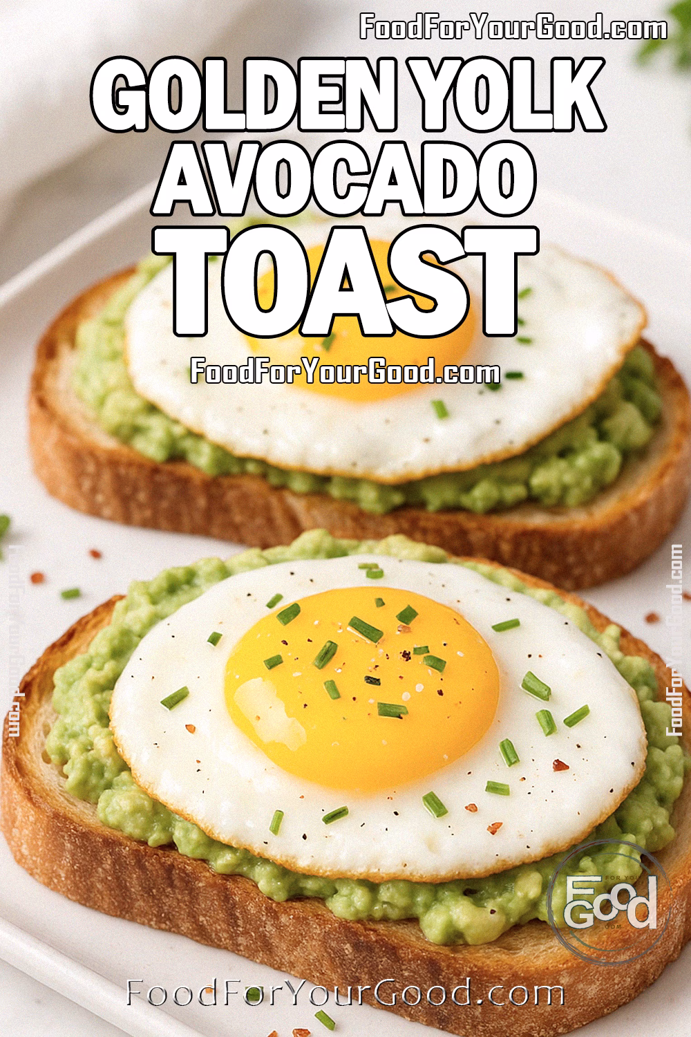 Golden Yolk Avocado Toast Recipe - FoodForYourGood.com Golden Yolk Avocado Toast on a white square plate, topped with mashed avocado, sunny-side up eggs, and fresh chives, styled on a marble surface with herbs blurred in the background.