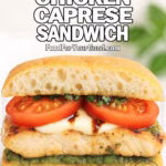 Two halves of a Grilled Chicken Caprese Sandwich on ciabatta with grilled chicken, mozzarella, tomato slices, chopped basil, and balsamic glaze on a white marble surface.