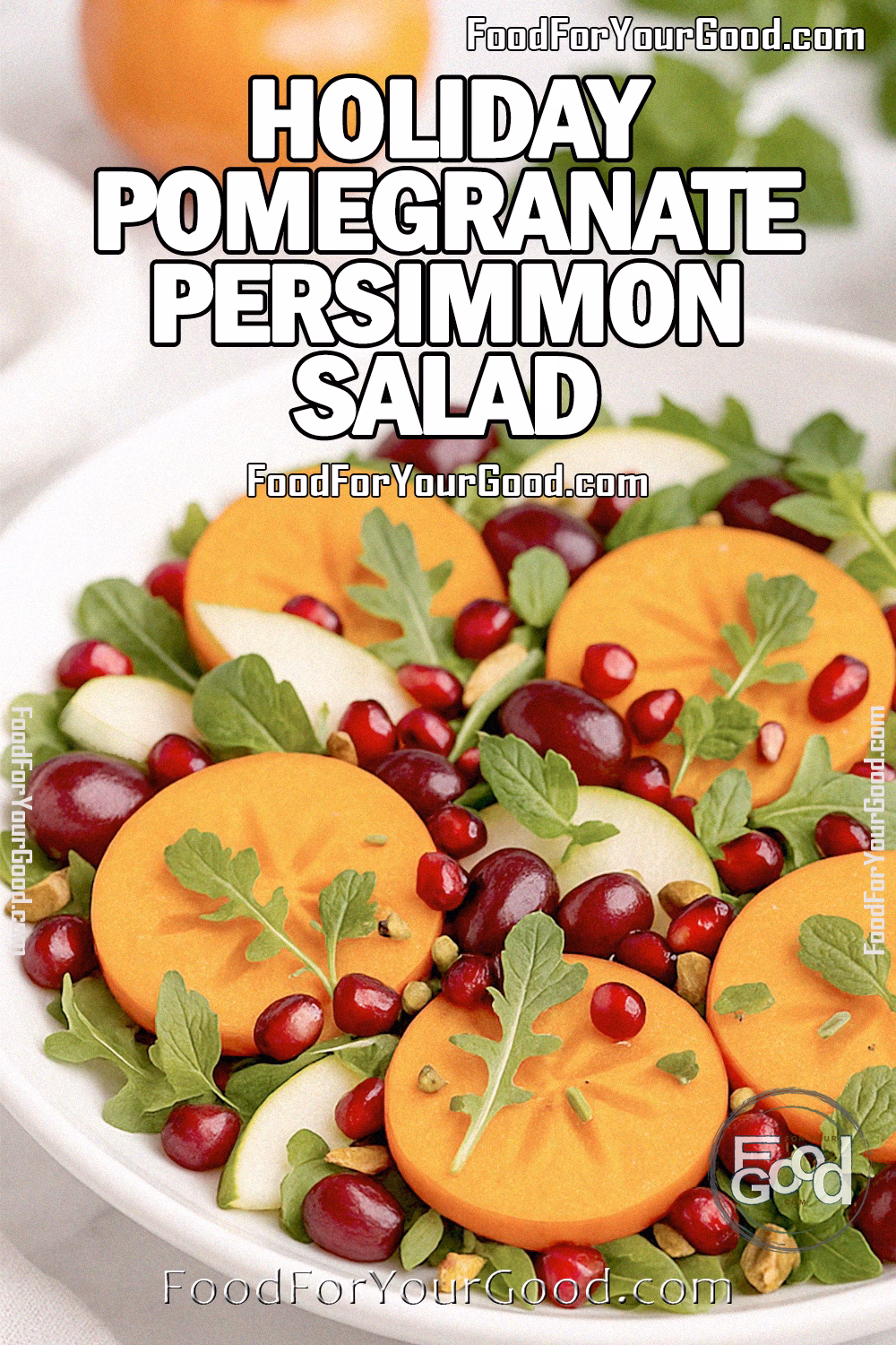 Holiday Pomegranate Persimmon Salad Recipe – FoodForYourGood.com Holiday Pomegranate Persimmon Salad with persimmon slices, pomegranate arils, grapes, pear, arugula, mint, and pistachios in a white bowl on marble.