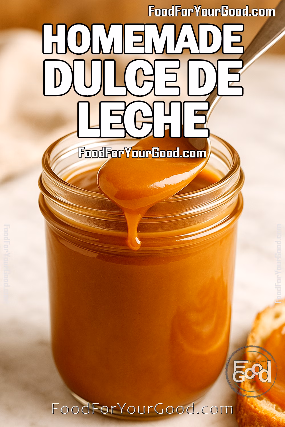 Creamy Golden Delight Dulce de Leche – FoodForYourGood.com Glass jar of creamy dulce de leche with spoonful and caramel-swirled bread on marble counter