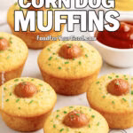 Honey Butter Corn Dog Muffins with crisp-edged hot dog centers, served on white marble with ketchup and mustard dips, and a soft white towel in the background.