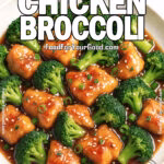 Honey Garlic Chicken Broccoli served on a white marble plate with golden chicken bites, vibrant broccoli, sesame seeds, and green onions in a glossy sauce.