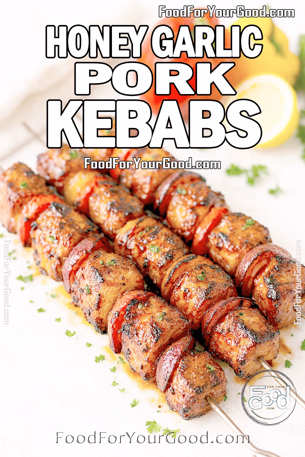 Honey Garlic Pork Kebabs grilled with peppers and onions, resting on marble with fresh herbs and lemon in the background.