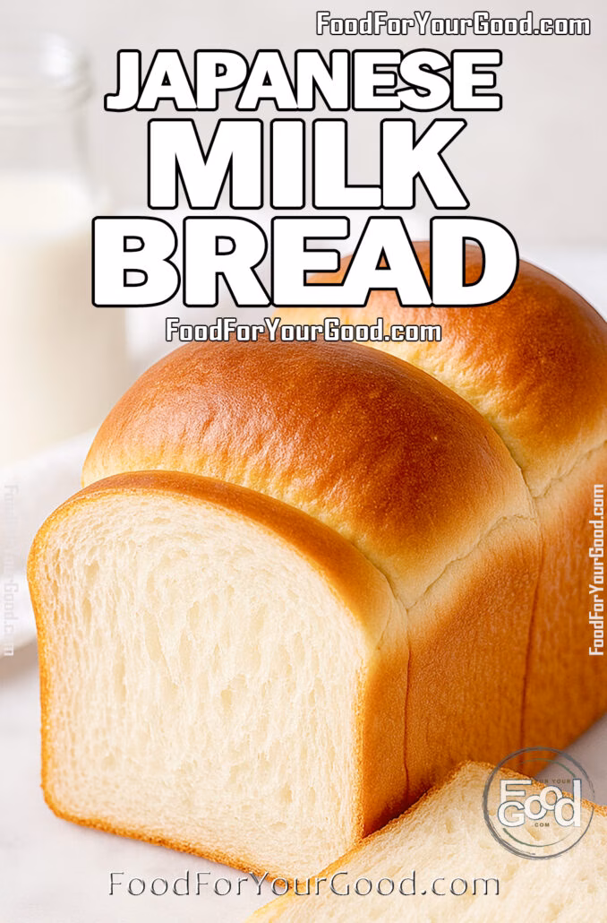 A golden loaf of Japanese Milk Bread with a fluffy interior on a marble surface, with a milk bottle and white towel blurred in the background.