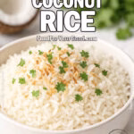 Bowl of Jasmine Coconut Rice topped with toasted coconut and cilantro on white marble with coconut in background.