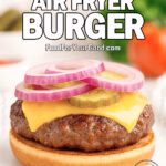 Juicy Air Fryer Burger patty with melted cheddar, pickles, and red onion rings on a toasted bun, styled on a marble board for FoodForYourGood.com