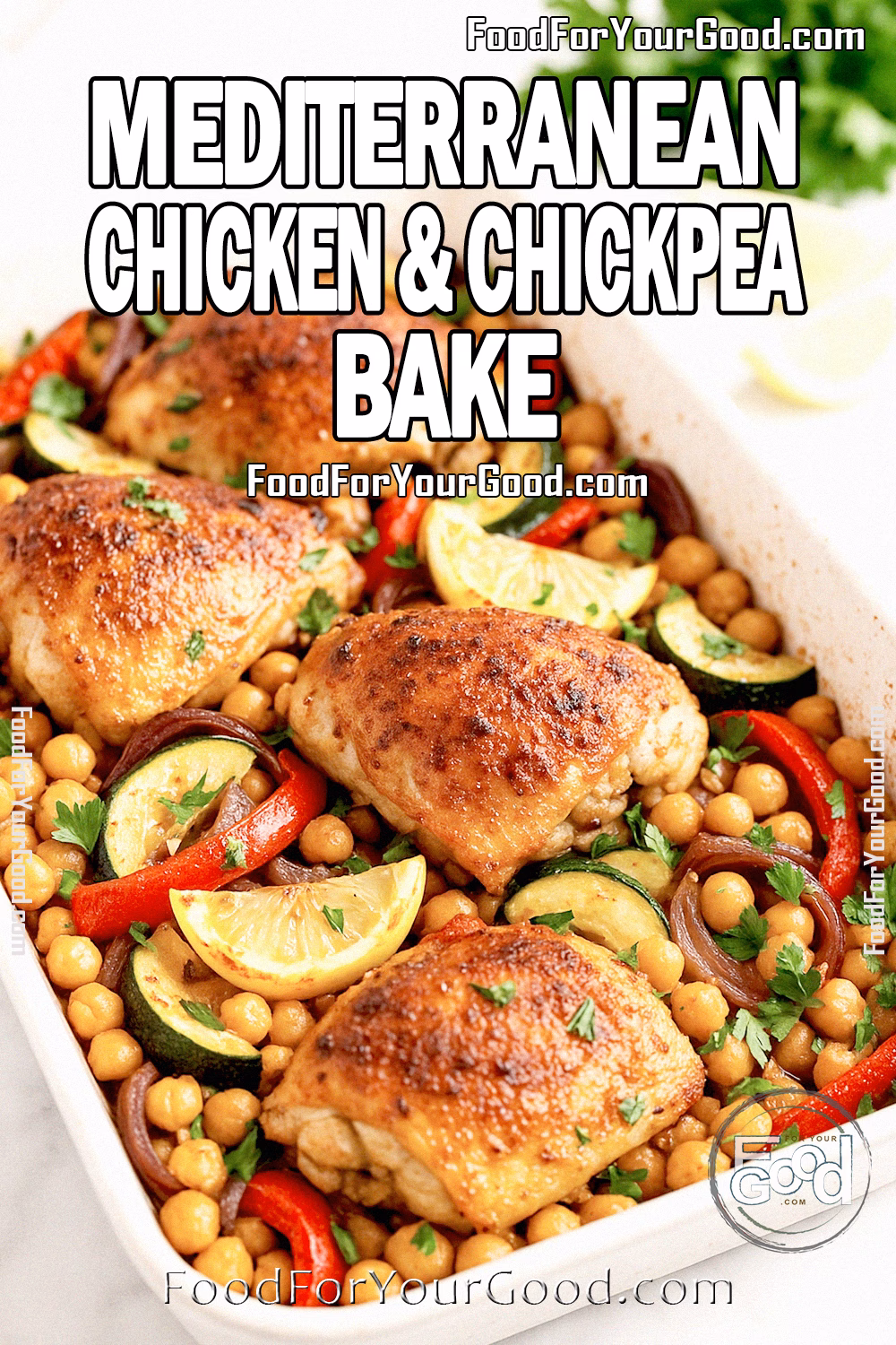 Mediterranean Chicken & Chickpea Bake Recipe - FoodForYourGood.com Mediterranean Chicken & Chickpea Bake with roasted chicken thighs, chickpeas, zucchini, peppers, and lemon wedges in a white baking dish on marble.