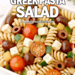 Mediterranean Greek Pasta Salad in a square cream ceramic bowl, with rotini pasta, cherry tomatoes, cucumbers, bell peppers, Kalamata olives, and cubed feta, coated in a glossy herb dressing for FoodForYourGood.com