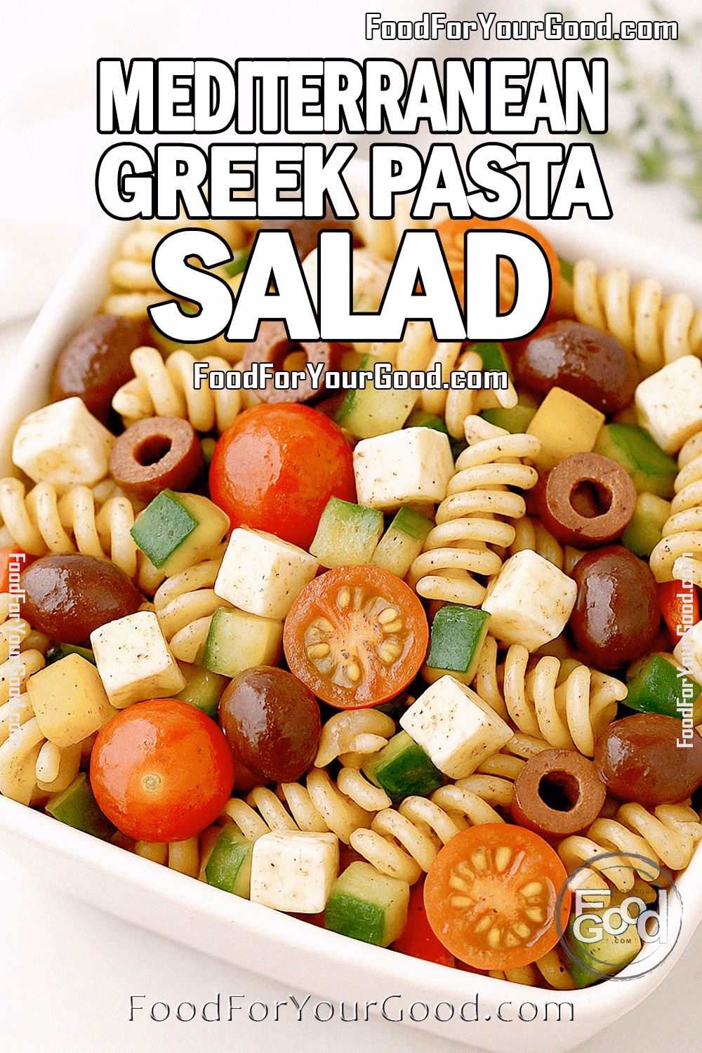 Mediterranean Greek Pasta Salad Recipe | FoodForYourGood.com Mediterranean Greek Pasta Salad in a square cream ceramic bowl, with rotini pasta, cherry tomatoes, cucumbers, bell peppers, Kalamata olives, and cubed feta, coated in a glossy herb dressing for FoodForYourGood.com