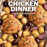 Mediterranean Roasted Chicken Dinner baked on a parchment-lined tray with golden chicken thighs, baby potatoes, red onions, garlic, and Kalamata olives, sprinkled with fresh parsley on a marble countertop.
