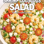 Mediterranean Shrimp Couscous Salad with feta, tomatoes, cucumber, and herbs served in a rustic bowl on marble