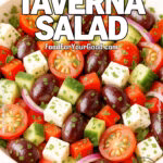 Mediterranean Taverna Salad in a ceramic bowl with cherry tomatoes, cucumber, red bell pepper, Kalamata olives, feta cubes, red onion, and parsley on a light surface.