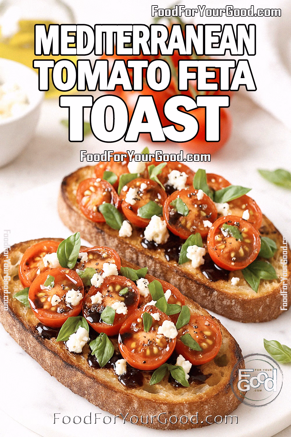 Mediterranean Tomato Feta Toast Recipe - FoodForYourGood.com Mediterranean Tomato Feta Toast on sourdough with cherry tomatoes, feta, basil, and balsamic glaze on marble.