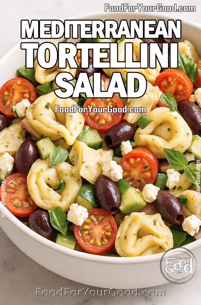 A bright Mediterranean tortellini pasta salad in a white ceramic bowl featuring cherry tomatoes, olives, artichokes, cucumber, feta, and basil.