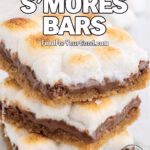 Melty Gooey S’Mores Bars stacked on a white marble surface with toasted marshmallows, melted chocolate, and buttery graham cracker crust.