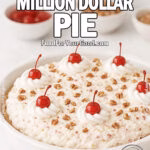 Homemade Pineapple Pecan Million Dollar Pie in a white ceramic dish on marble countertop, topped with whipped cream swirls, cherries, and pecans.