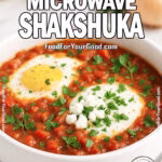 Quick Microwave Shakshuka in a white bowl topped with parsley and feta on marble countertop.