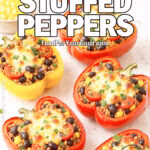 Quinoa Veggie Stuffed Peppers on FoodForYourGood.com – colorful bell peppers filled with quinoa, black beans, corn, tomatoes, and melted cheese, garnished with fresh parsley.